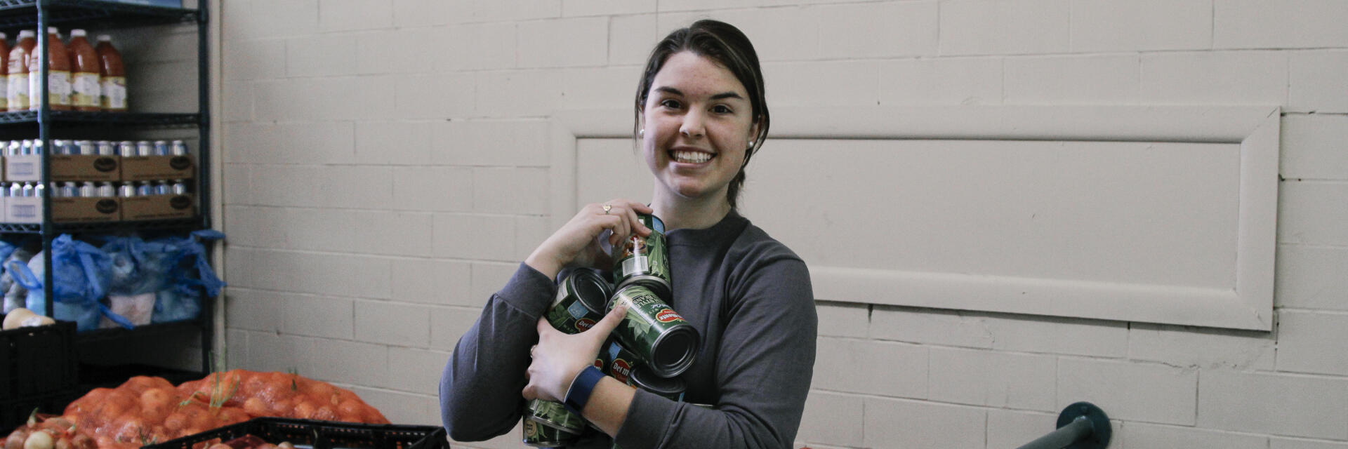 Student holding canned vegatables